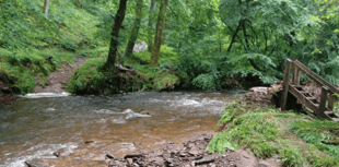 Bridge swept away as storms cause flooding
