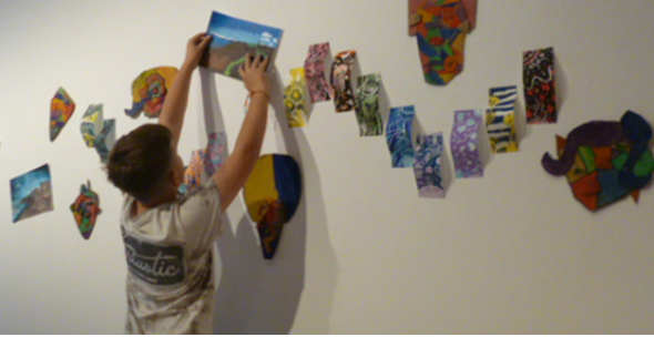 Putting the finishing touches to a display in East Quay, Watchet, of Minehead Middle School artwork. PHOTO: MMS.
