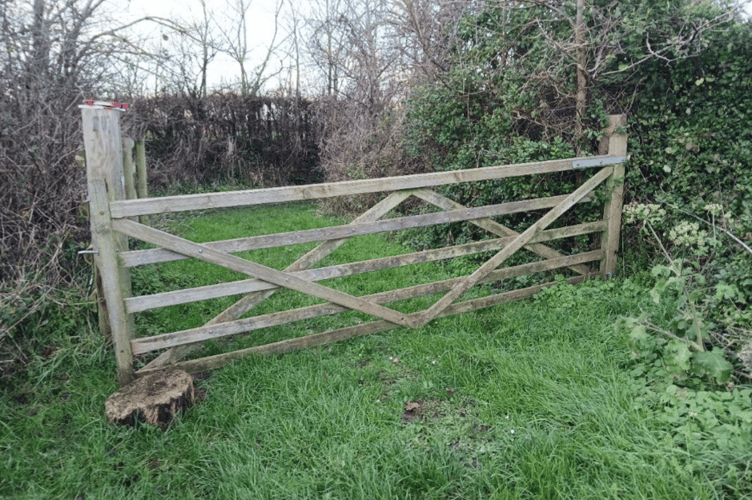 This wooden gate will be replaced with a six feet high steel entrance to playing fields for Stogursey Primary School. PHOTO: Quantock Education Trust.