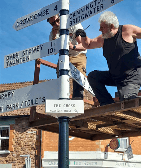 The finishing touches being put to a restored fingerpost in the centre of Nether Stowey. PHOTO: Nether Stowey Parish Council.