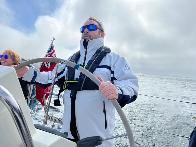 Crew member Vince Manley at the helm of the Stride Forward yacht. PHOTO: Stride Forward.