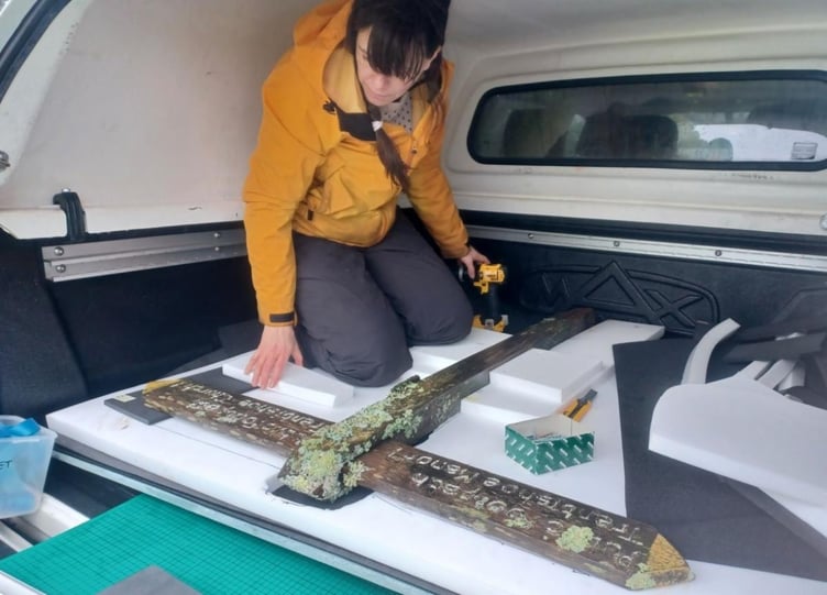 Natural History Museum lichen curator Gothamie Weerakoon collects a lichen-covered fingerpost from Exmoor to feature in an exhibition. PHOTO: ENPA.