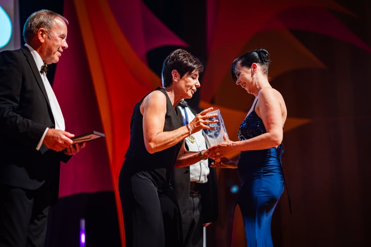 JoJo Ziauberyte of Amicus Law collects the Paralegal of the Year award