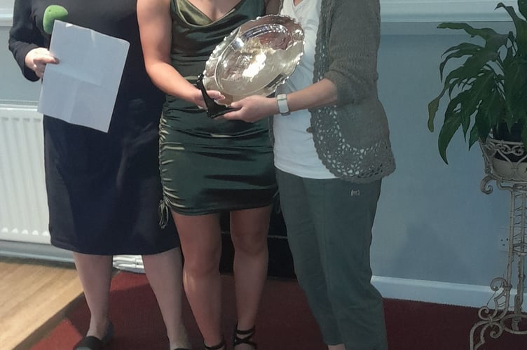 Jess Koppa is presented with an award by club chair Jan Weetch and president Eileen Denley
