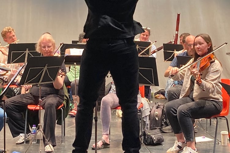 Conductor Christopher Stark in full flight during rehearsal - Minehead music festival