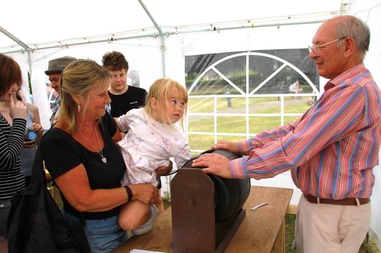 Thre year old Aria Lewis picking a tombola ticket with the help of Ian Aldridge