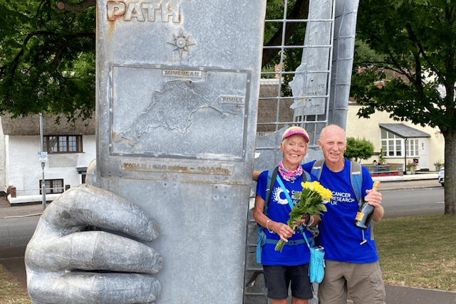 Husband and wife cancer survivors walk coast path