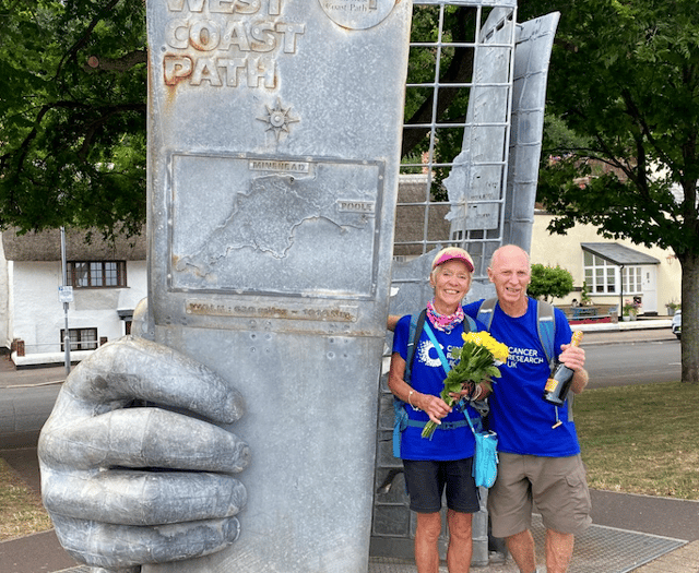 Husband and wife cancer survivors walk coast path