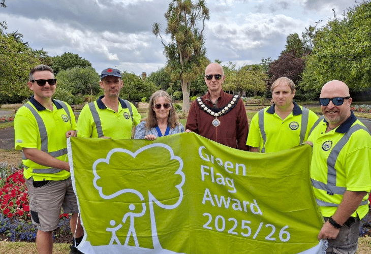 Minehead Mayor Cllr Craig Palmer and deputy mayor Cllr Anne Lawson celebrate a Green Flag award for Blenheim Gardens with some of the town council's open spaces team.
