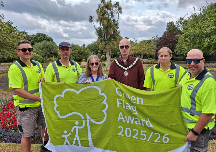 Minehead Mayor Cllr Craig Palmer and deputy mayor Cllr Anne Lawson celebrate a Green Flag award for Blenheim Gardens with some of the town council's open spaces team.