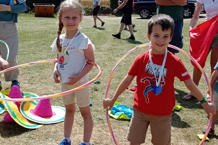 Hula hoop racers Erin Buswell, aged six, and Henry Black, five, at Fitzhead Fete.