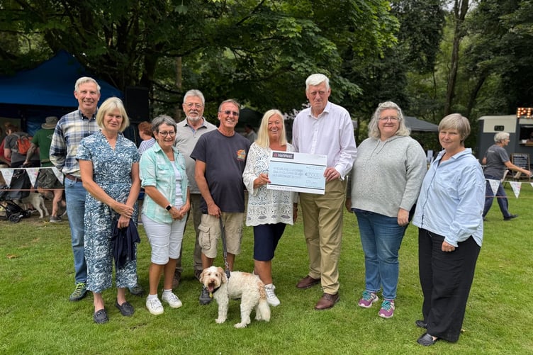 Pictured are (left to right) Dulverton gardeners Pete and Nicky Walker, gardeners Anne and Keith Markwick with their dog Cobo with gardener and Visit Dulverton volunteer Steve Huckins behind, Christine Dubery, John Preston, Moorland Food Bank secretary Roz Matthews, and food bank trustee and Somerset Cllr Frances Nicholson.