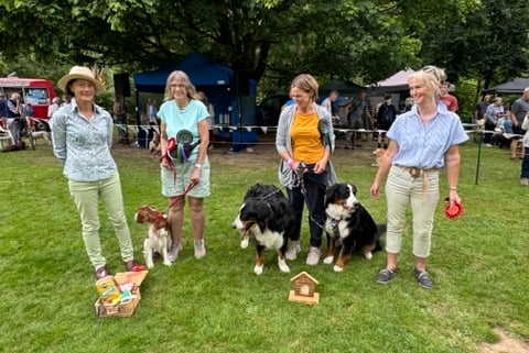 Dulverton dog show (left to right) judge Pauline Tolhurst, reserve champion Welsh Springer Lottie and Helen Haig, champion Bernese mountain dog Olive with mother Lara and Lisa Joslin, and steward Sue Blackmore. PHOTO: Visit Dulverton.
