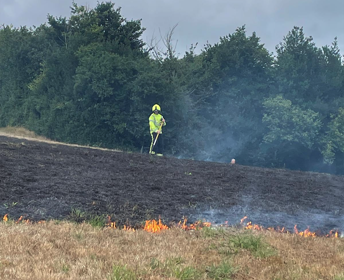 A Wiveliscombe firefighter tackling a grass fire on the Quantock Hills. PHOTO: DSFR.