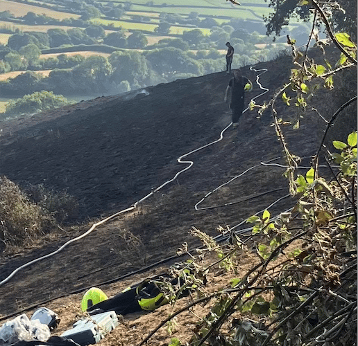 Minehead firefighters at the scene of one of many grass fires they tackled in July. PHOTO: DSFR.