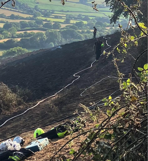 Minehead firefighters at the scene of one of many grass fires they tackled in July. PHOTO: DSFR.