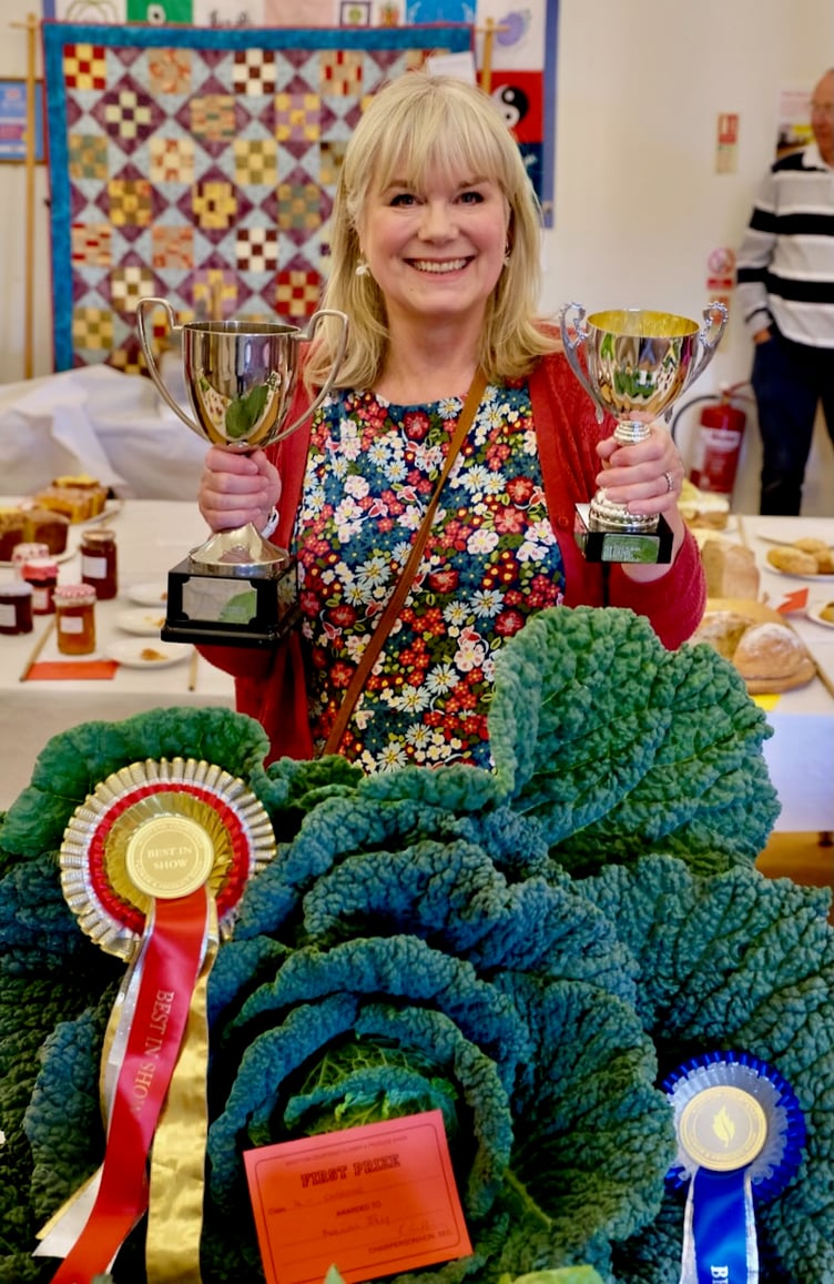 Marion Jay with her prize-winning cabbage at Wootton Courtenay Flower and Produce Show. Photo: Bill Hodgson.