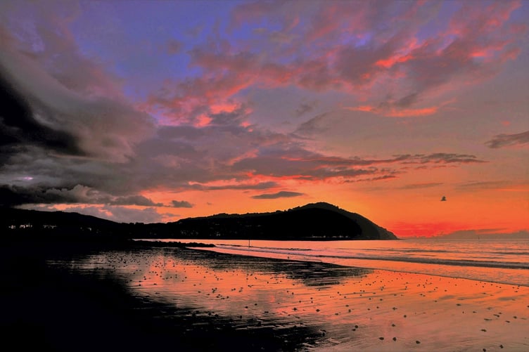 Stunning colours as the sun sets across Minehead Bay and North Hill