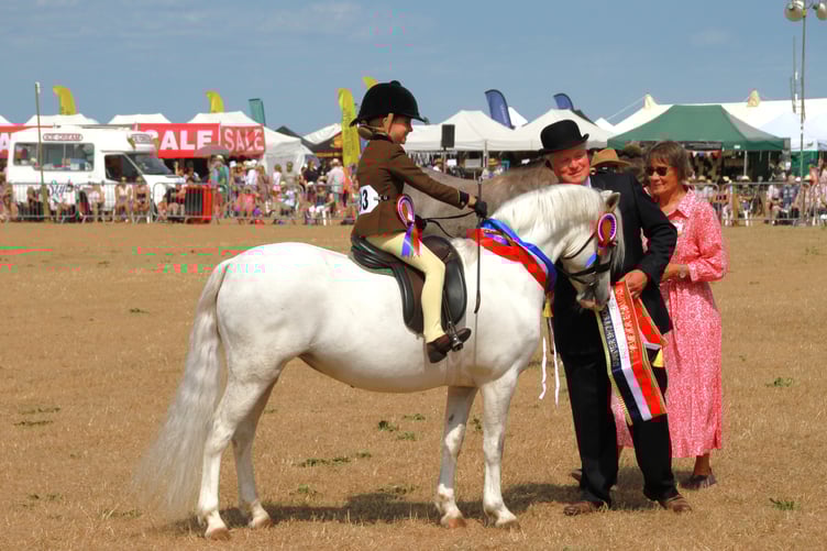 Charlotte Knight collects her 'best in show' award at Dunster Show 2025.