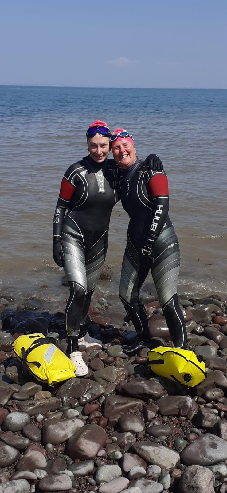 Sarah McLaughlin (left) and Hannah Bays finish their Minehead to Porlock Weir swim.