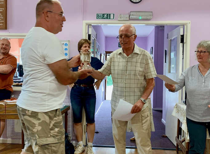 Andy Heard (left) receives a trophy from village hall chairman Martin Booth at Timberscombe Show.
