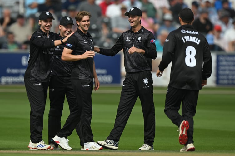 Tom Lammonby (third left) is congratuled by his teammates on his five-wicket haul