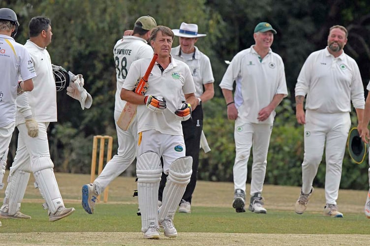 Ashbrittle and Brompton Ralph's players take a break for tea during their first division game in the WS League 