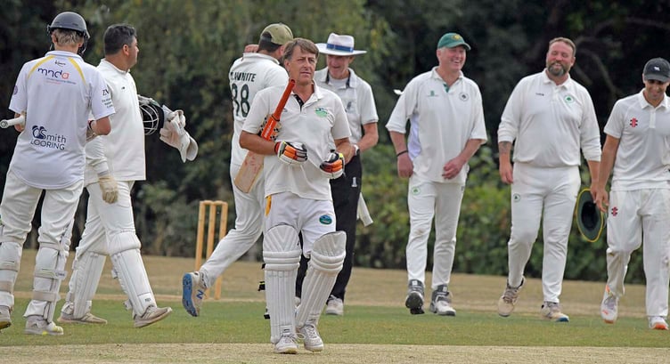 Ashbrittle and Brompton Ralph's players take a break for tea during their first division game in the WS League