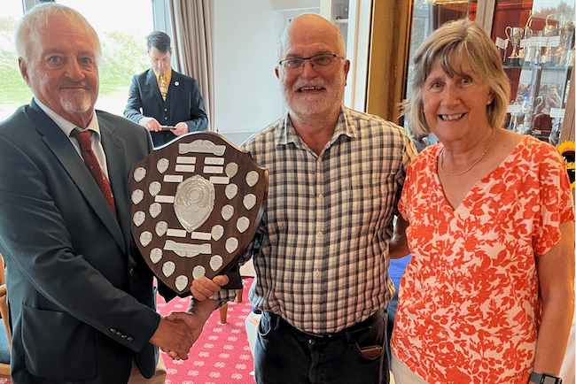 Ian Gover (centre) receives the Arnold Palmer Trophy from club capt Doug Hayhoe and lady captain Pat Lucas