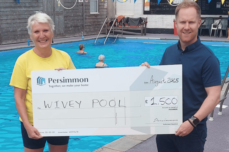 Wivey Pool chairman Liz Hurry receives a cheque from Persimmon Homes head of external affairs Chris Thorne.