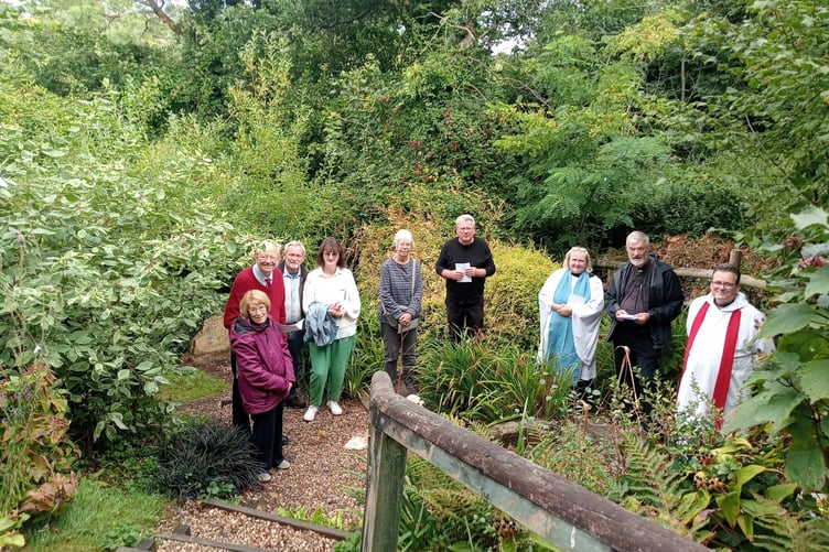 The Rev Mark Phillips with some of the churchgoers who gathered at the Holy Well for the traditional start of St Decuman’s Day celebrations.