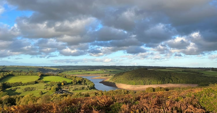 A distant view of Wimbleball Lake, on Exmoor, outlined by bar banks as water levels drop significantly.