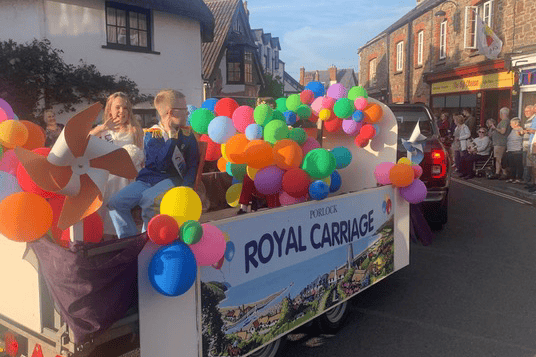 Porlock Carnival's royal carriage winds its way through the village centre.