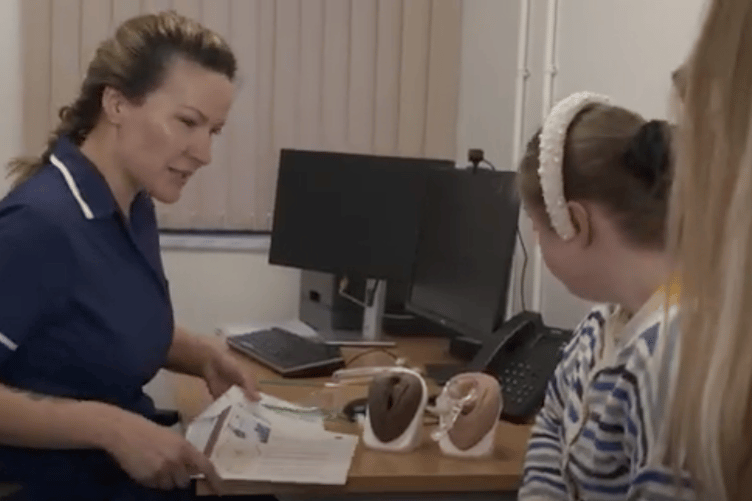 A nurse explains cervical screening for a patient.