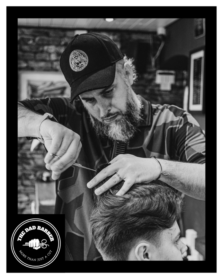 Daniel James, the 'Dad Barber', in action.