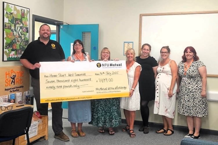 Agent Neil Brand presents a cheque to Home Start West Somerset staff.