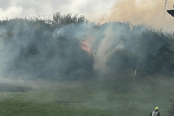 Fire crews battled a blaze near the old mineral line in Watchet caused when power cables snapped and fell.