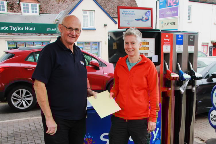 Williton filling station manager Les Woodward receives a retirement gift from Caroline Duder.