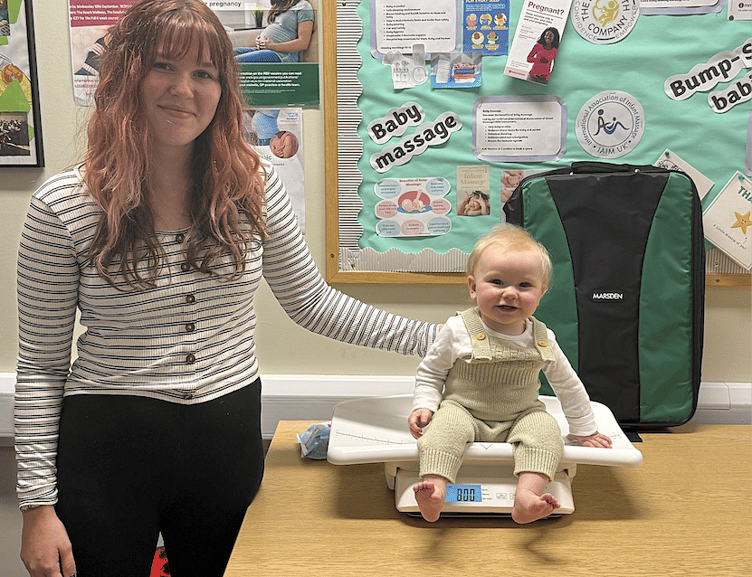 Izzy Norman with her baby Rory weighing in at Home-Start West Somerset.