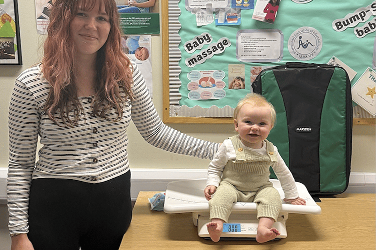 Izzy Norman with her baby Rory weighing in at Home-Start West Somerset.