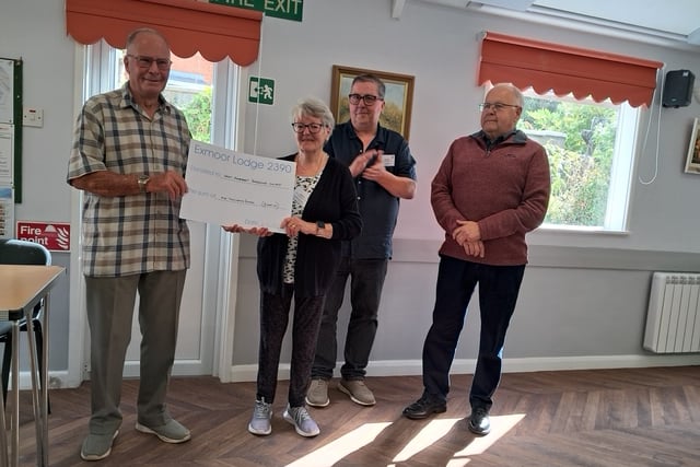 A cheque presentation by Masonic Lodge Worshipful Master Bob King to WASPS treasurer Tegwen Richards is watched by Alan Sandler and Ralph Gale.