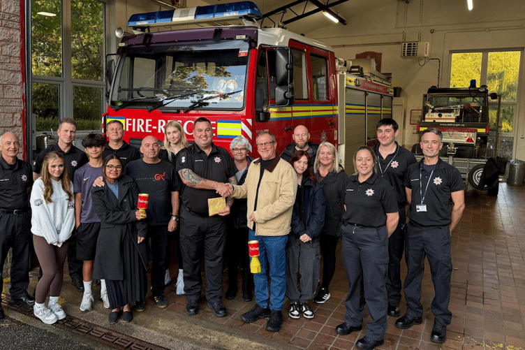 Family of the late Pauline Foster visit Nether Stowey firefighters to hand over a charity collection in her memory.