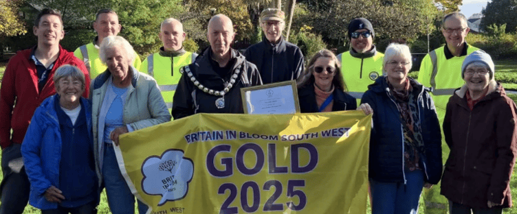 Minehead Mayor Cllr Craig Palmer (centre) with town council staff and volunteers who helped the town win gold in the South West in Bloom Awards.