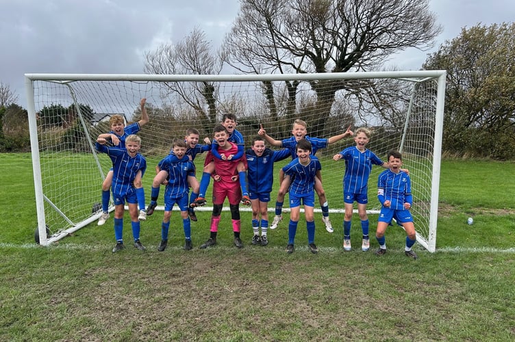 Minehead U12 Blues celebrate their cup win at Berrow