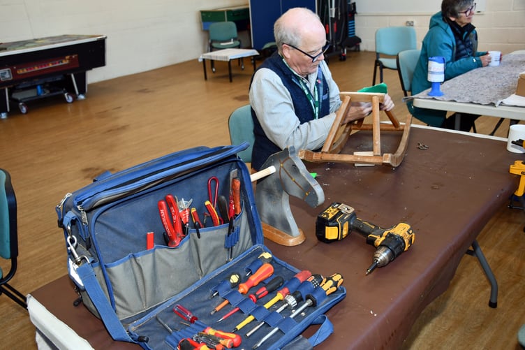 A rocking horse being mended by a volunteer in Watchet Repair Café.