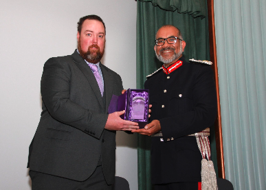 Retiring Exmoor Young Voices chairman Will Lock receiving the King's Award for Voluntary Service from Lord Lieutenant of Somerset Mohammed Saddiq.