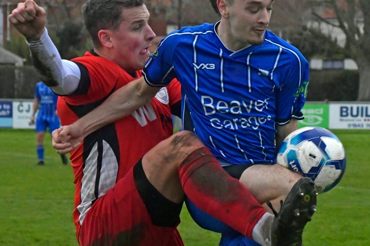 Minehead's in-form striker Toby Waghorn (in blue)