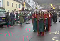 Medieval re-enactors and torchlight procession light up Dunster for winter festival