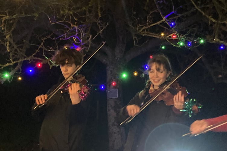 Luca and Sophie Gasperini joined Carhampton's village band with mum Ruth and grandfather Keith Jones for the community orchard Christmas lights switch on.