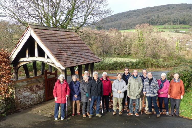 Minehead Town Council clerk Ben Parker (centre, rear) shows members of the town's conservation society the newly-restored cemetery lychgate.